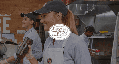 Jersey mikes logo overlaying image of a woman and two men working behind a counter