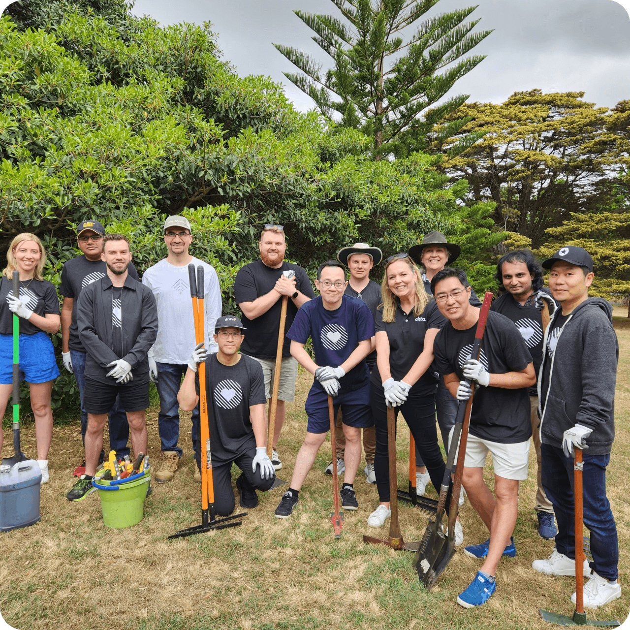 Okta employees posing for a photo while volunteering