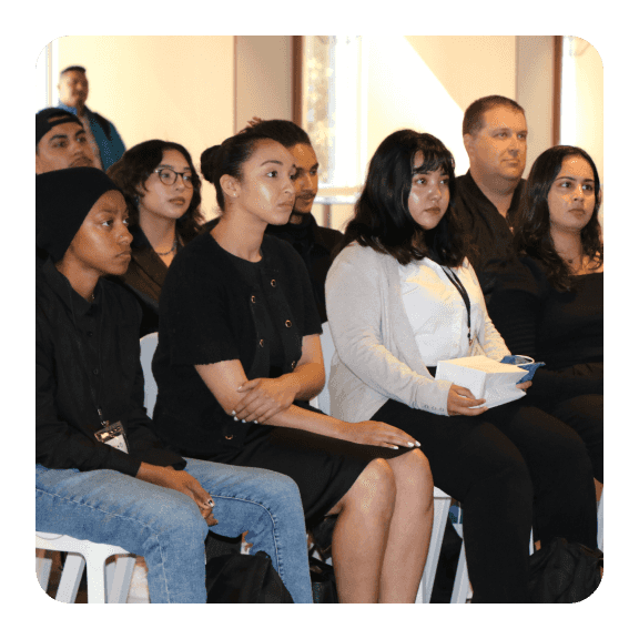 Image of people sitting while watching presentation