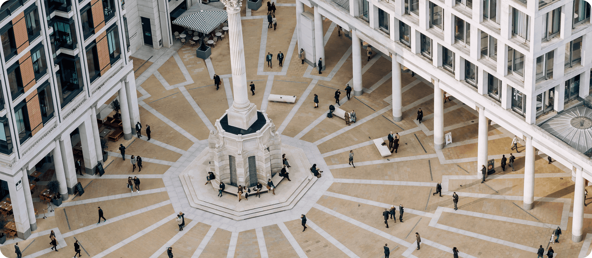 Aerial view of people outside of a government building. 