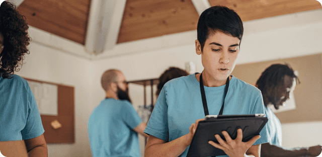 Employee in uniform looking at tablet