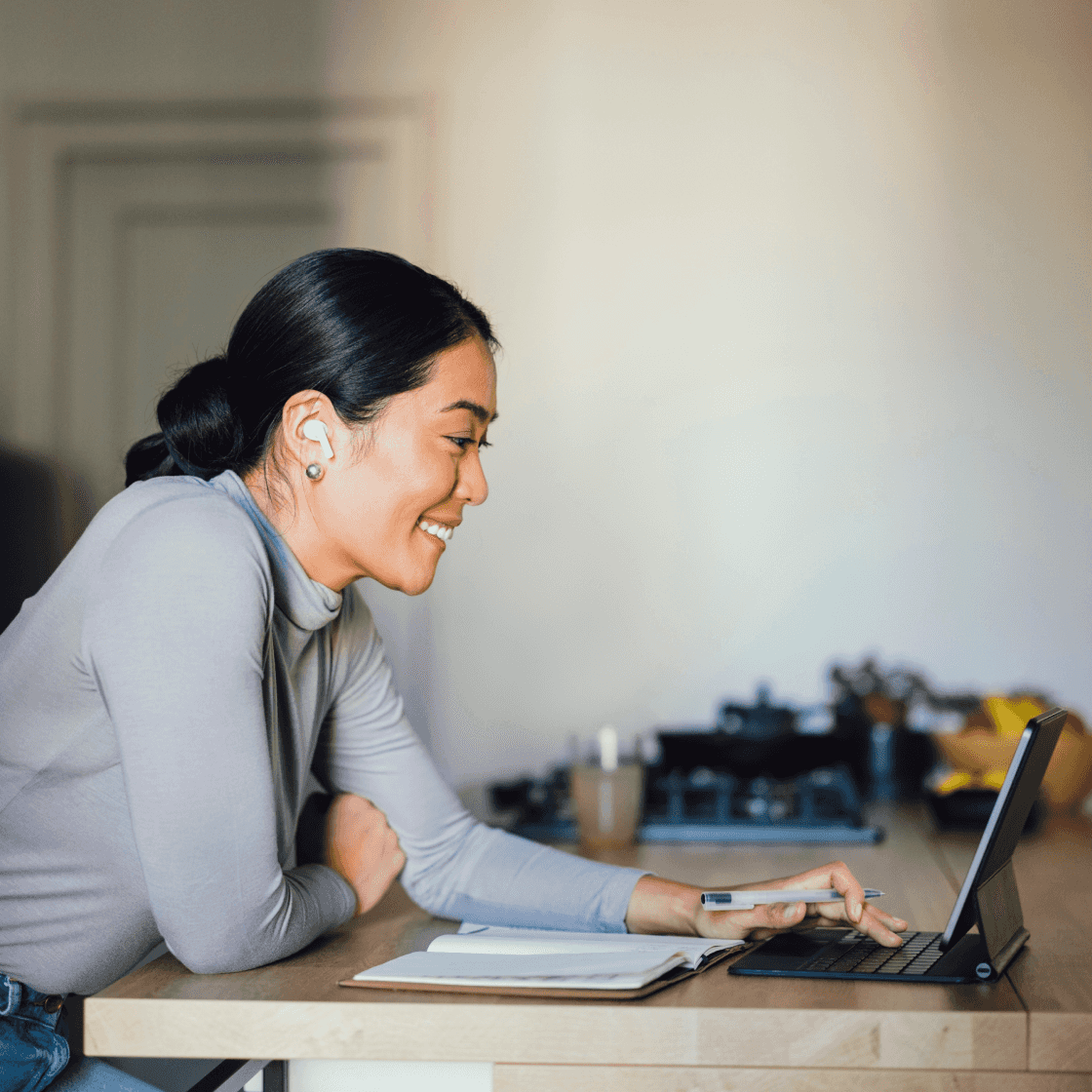 Woman sitting at desk while using laptop