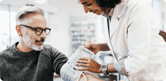 Doctor checking blood pressure of patient.