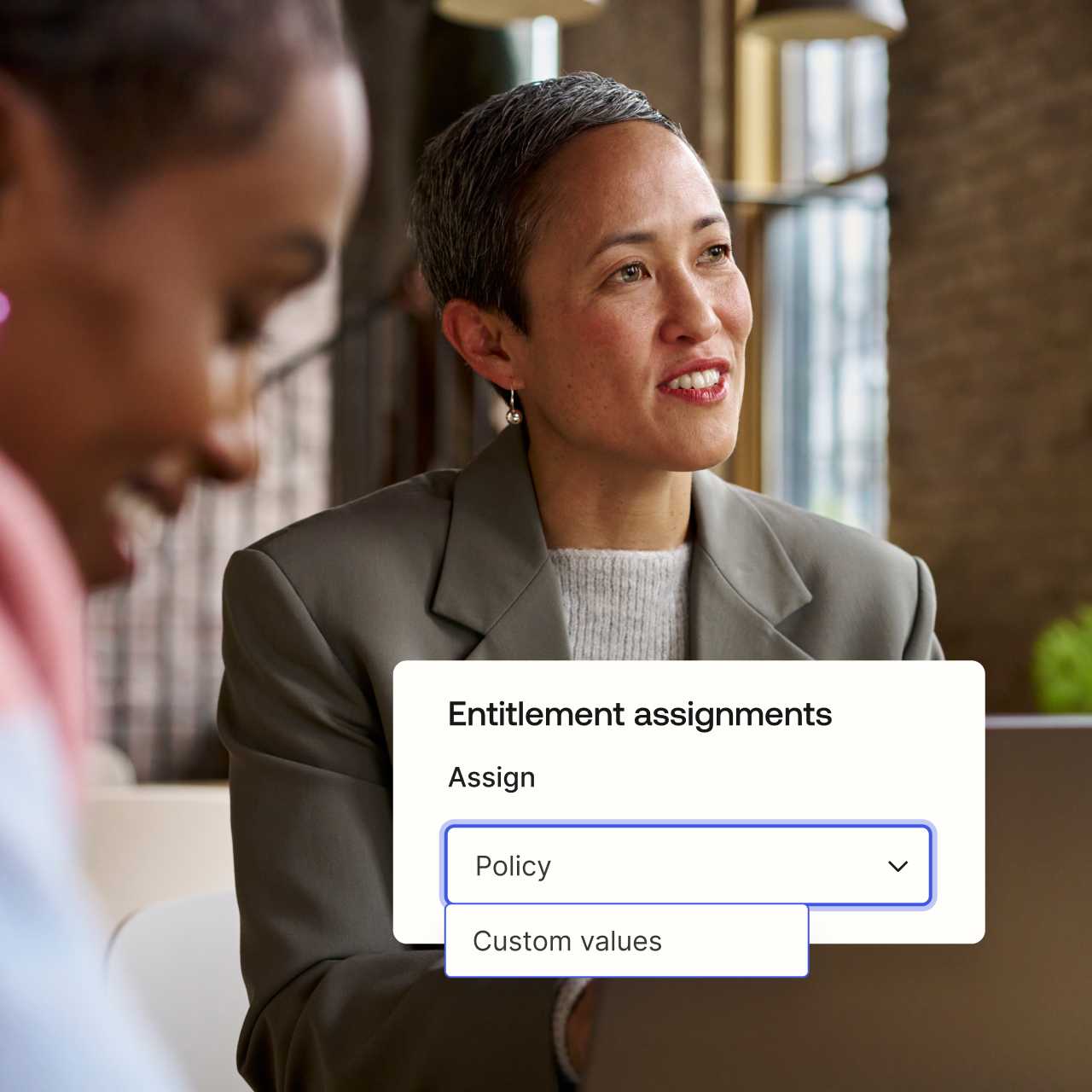 Entitlement assignments module overlaying image of two women.