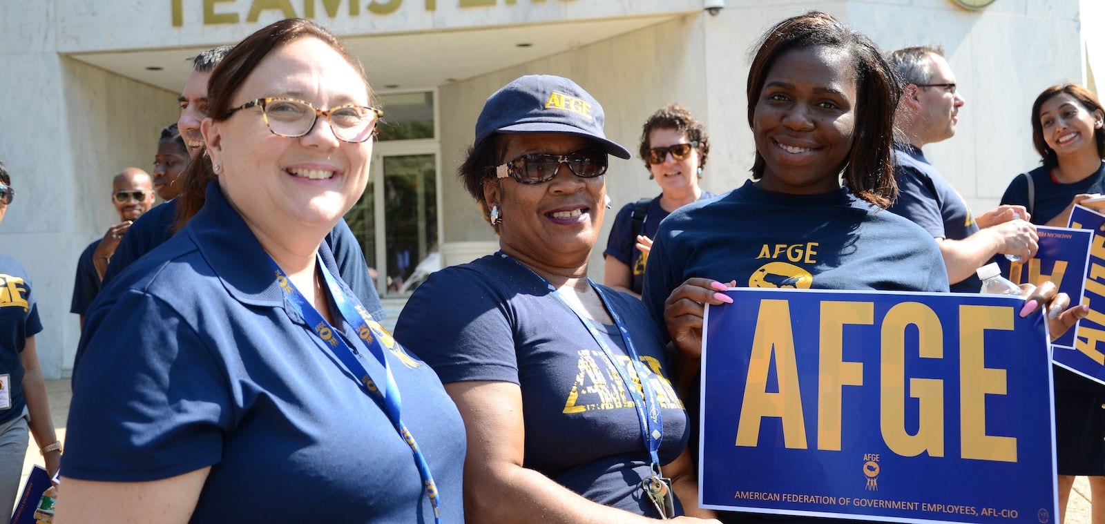 a group of employees outside the building