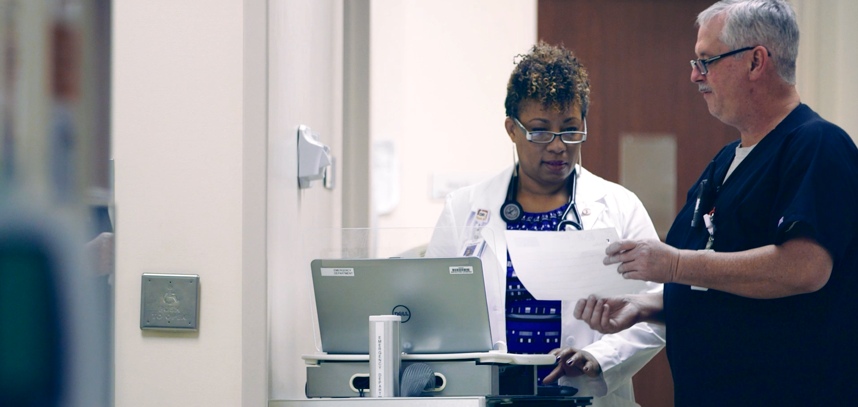 Two healthcare professionals checking a report together