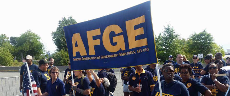 people at a rally with afge transparent