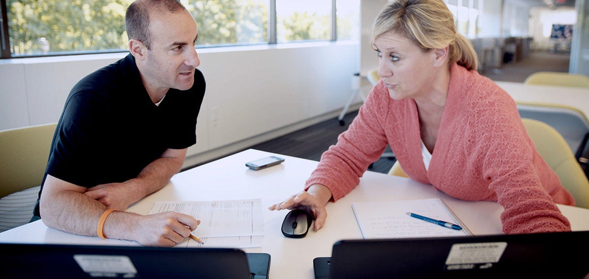 Two employees discussing in the office