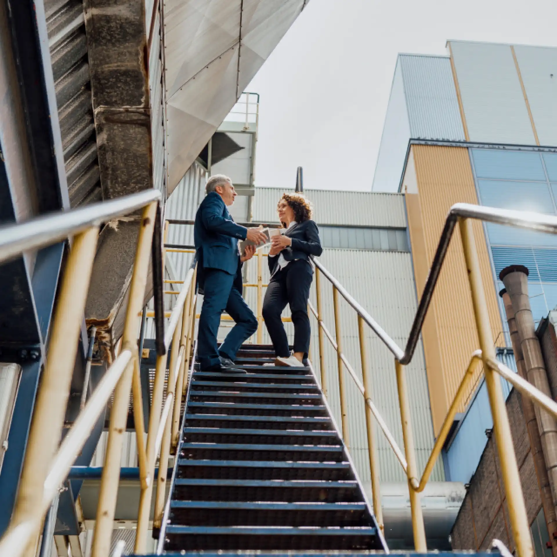 Office workers chatting on stairs